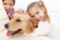 Little girl hugging pet dog smiling