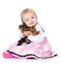 Little girl hugging a puppy Yorkshire Terrier. on white