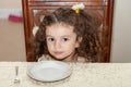 Little girl hungry and waiting for food Royalty Free Stock Photo