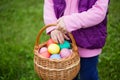 Little girl hunts Easter egg. Kids searching eggs in the garden.