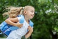 A little girl hurries to school with a backpack. The concept of school, study, education, friendship, childhood. Royalty Free Stock Photo