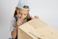 Little girl in the image of garbage furniture spins