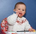 The little girl independently eats with a spoon Royalty Free Stock Photo