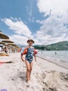 Little girl in inflatable armlets stands on the beach Royalty Free Stock Photo