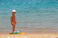 Little girl with inflatable circle on summer holidays at sea