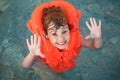 Little girl in inflatable waistcoat in pool Royalty Free Stock Photo