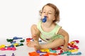 A little girl inflates balloons. Royalty Free Stock Photo