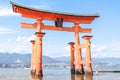 Little girl at the Itsukushima shrine great orange gate O-torii at the Miyajima island in Hiroshima Japan Royalty Free Stock Photo