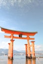 Little girl at the Itsukushima shrine great orange gate O-torii at the Miyajima island in Japan Royalty Free Stock Photo