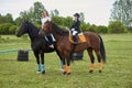 Little girl jockey and her coach ridding a horse