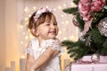 Little girl joyfully laughs on a background from Christmas illumination