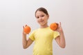 Little girl with juicy oranges