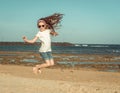 Little girl jump on a beach Royalty Free Stock Photo