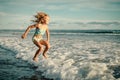 Little girl jumping on the beach