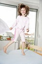 Little girl jumping on a bed Royalty Free Stock Photo