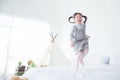 Little girl jumping on bed at home Royalty Free Stock Photo