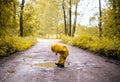 Little girl jumping fun in a dirty puddle Royalty Free Stock Photo