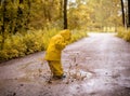 Little girl jumping fun in a dirty puddle Royalty Free Stock Photo