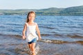 Little girl jumping over a river wave Royalty Free Stock Photo