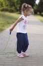 Little girl jumping skipping rope