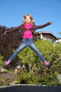 Little girl jumping on trampoline Royalty Free Stock Photo