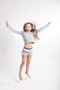 Little girl jumps on a white background Royalty Free Stock Photo