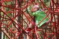 Little girl on jungle gym ropes Royalty Free Stock Photo