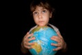 Little girl keeps in hands over globe of world Royalty Free Stock Photo