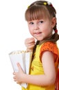 Little girl keeps package with popcorn