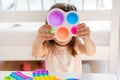 Little girl,kid,child plays with colorful pop it children`s room, bedroom.Funny trendy silicone antistress colorful sensory push