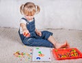 Little girl kid playing with education mosaic pins Royalty Free Stock Photo