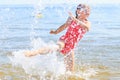 Little girl kid splashing in sea ocean water. Fun Royalty Free Stock Photo