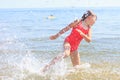 Little girl kid splashing in sea ocean water. Fun Royalty Free Stock Photo