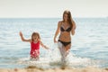 Little girl kid and woman mother in sea water. Fun Royalty Free Stock Photo