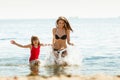 Little girl kid and woman mother in sea water. Fun Royalty Free Stock Photo