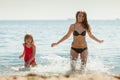 Little girl kid and woman mother in sea water. Fun Royalty Free Stock Photo