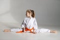 Little girl kimono fighter on a twine on a white background