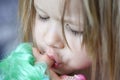 A little girl kisses a doll with bright hair on her lips Royalty Free Stock Photo