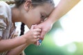 Little girl kisses her mother`s hand, summer nature outdoor. Happy smiling kid feels grateful Royalty Free Stock Photo