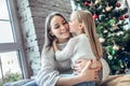 Little girl kissing her mom on the cheek Royalty Free Stock Photo