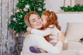 Little girl kissing her mom at christmas photo Royalty Free Stock Photo