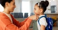 Little girl kissing her mother. Young mother hugging her daughter. Loving mother hugging daughter before school outside Royalty Free Stock Photo