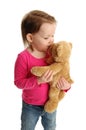 Little girl kissing teddy bear