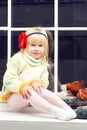 Little girl in a knit sweater and looks the camera Royalty Free Stock Photo