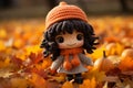 a little girl in a knitted hat and sweater standing in a pile of fall leaves