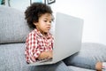 Little girl with laptop .afircan kid using laptop. Royalty Free Stock Photo