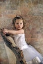 Little girl in a large antique chair