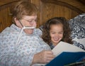 Woman on oxygen reads to little girl Royalty Free Stock Photo