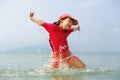 Little girl laughing and crying in the spray of waves at sea