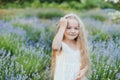 Little girl in lavender field. kids fantasy. Smiling girl sniffing flowers in summer purple lavender field Royalty Free Stock Photo